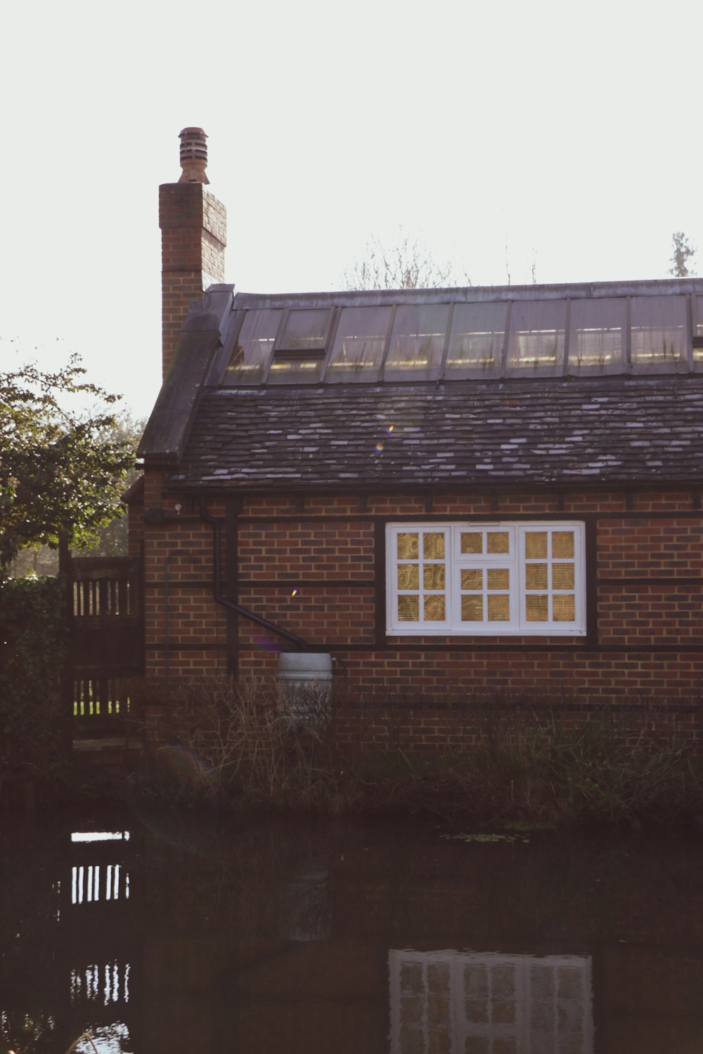 brown brick house near green trees during daytime