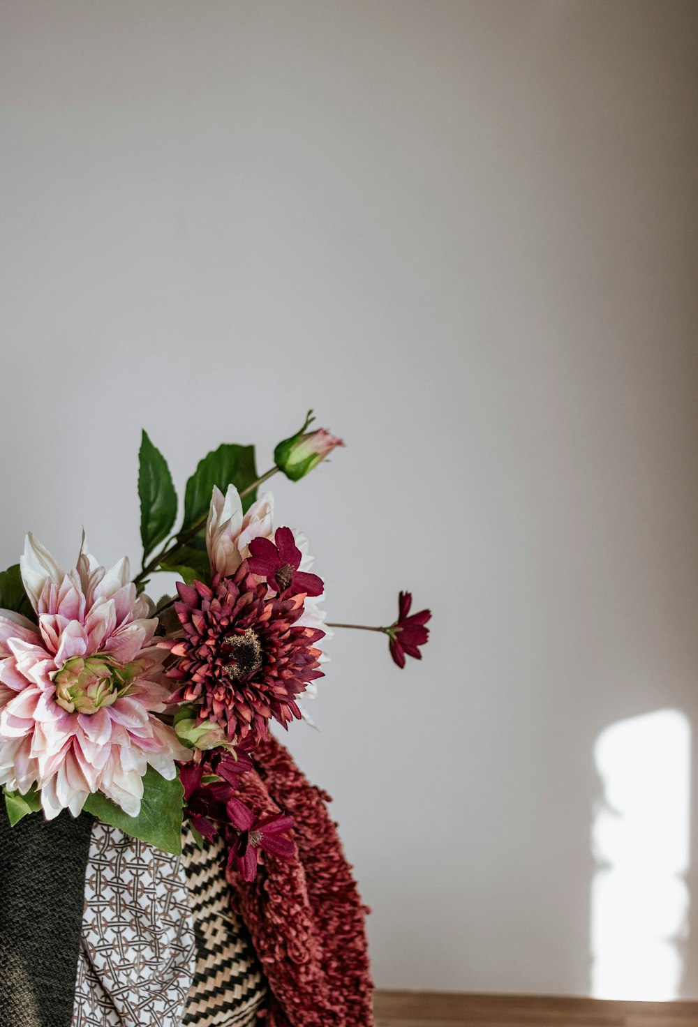 pink and white flowers on white ceramic vase