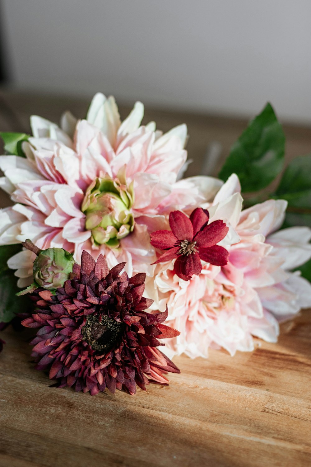 pink and white flower on brown wooden table