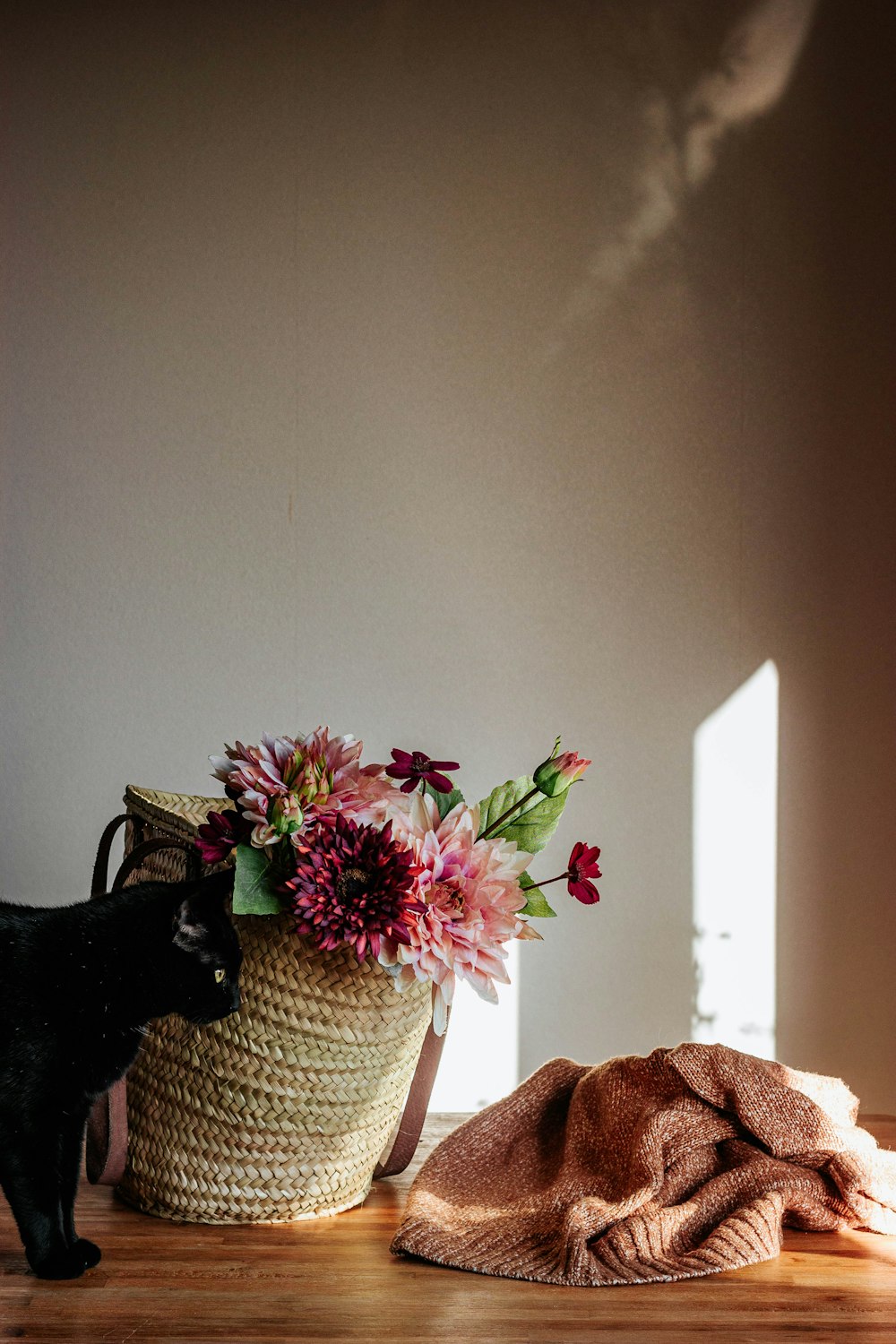 pink and yellow flower on white wicker basket