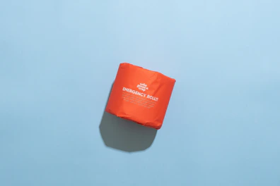 Close-up of compact emergency food packs with neon orange accents.