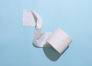 white toilet paper roll on white table