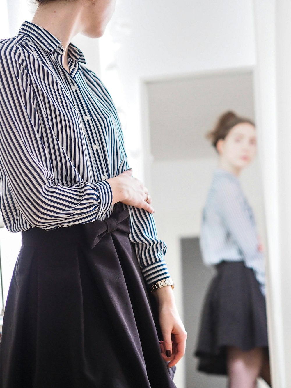 woman in black and white stripe long sleeve dress