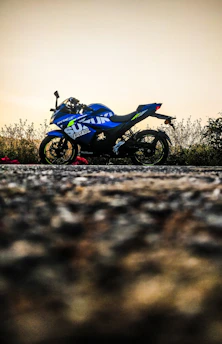 Motorcycle being carefully loaded onto a tow truck with a blue and white color scheme