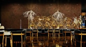 A luxurious and sophisticated interior space featuring elegant dining tables and chairs with black upholstery and wooden accents. The walls have a reflective, geometric design with intricate, illuminated floral decorations. The floor showcases a polished, patterned surface, contributing to the high-end atmosphere.