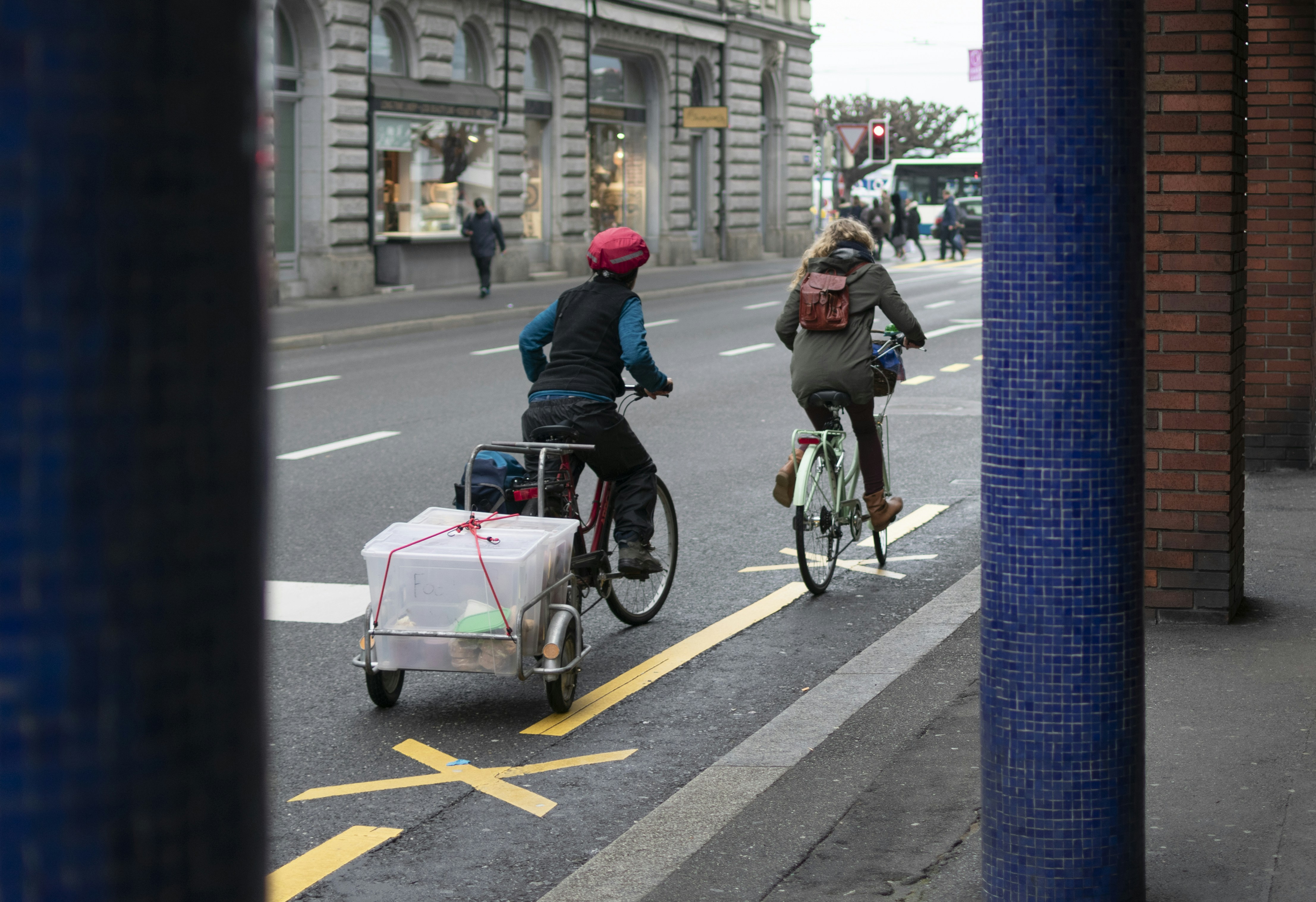 man in blue jacket riding bicycle on road during daytime