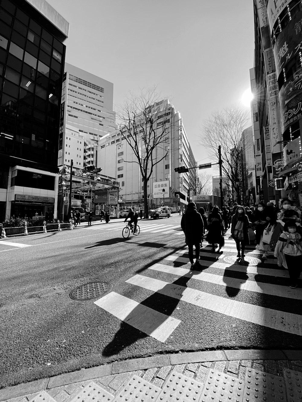 grayscale photo of people walking on pedestrian lane