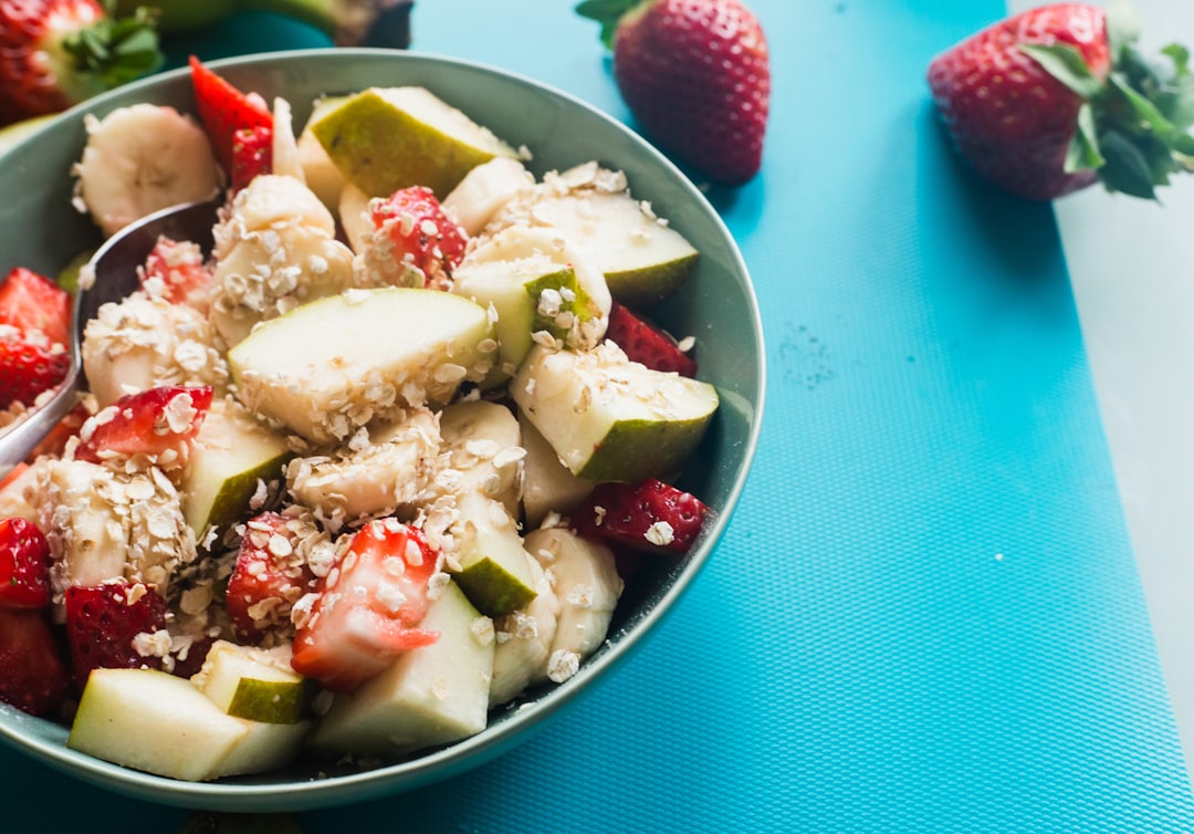 white cream with strawberry on white ceramic bowl