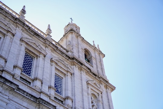 beige concrete building under blue sky during daytime in Monastery of São Vicente de Fora Portugal