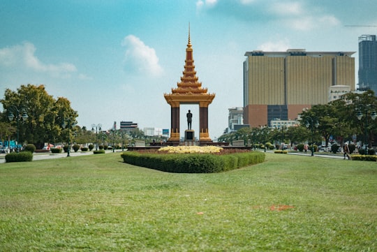 gold and white concrete building in Independence Monument Cambodia