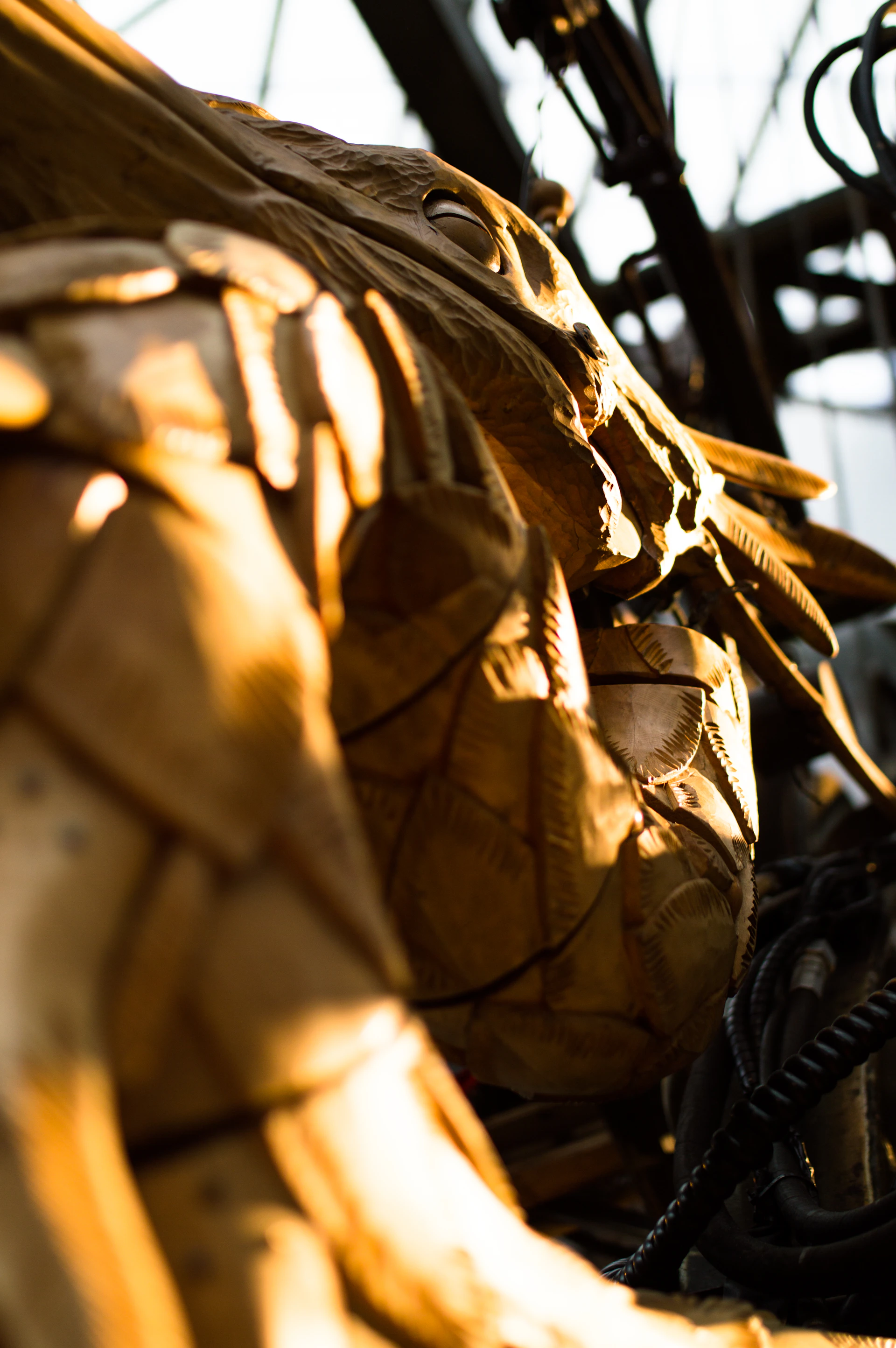 A detailed close-up of a textured sculpture made from reclaimed wood and metal.