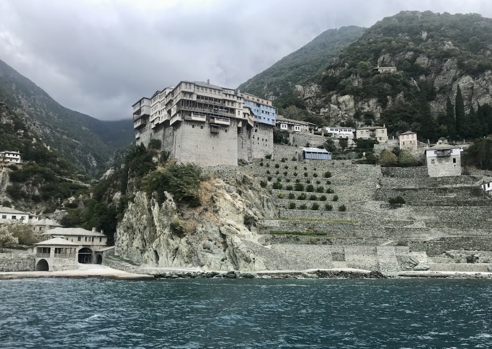 white and brown concrete building near body of water during daytime