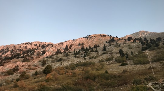 brown rock formation under blue sky during daytime in Mount Athos Greece