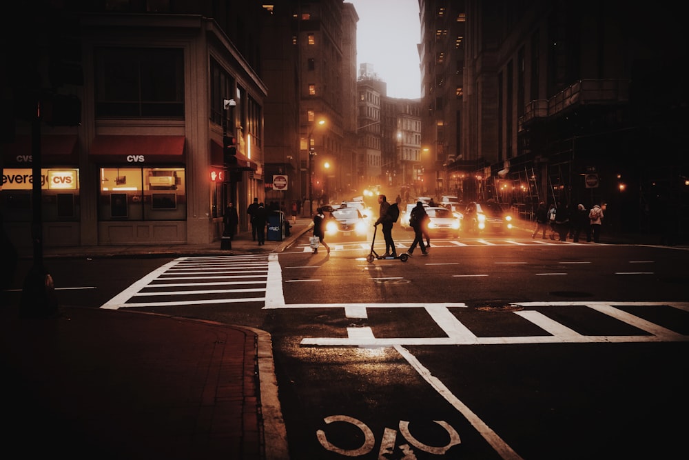 people walking on pedestrian lane during night time