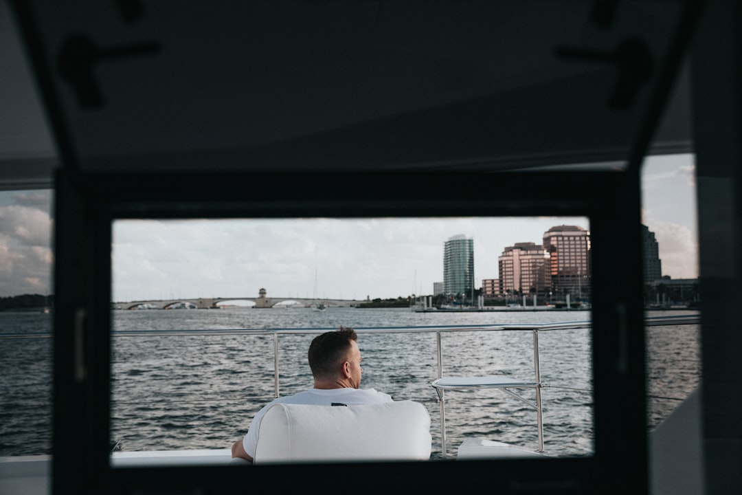 man in white shirt sitting on boat during daytime