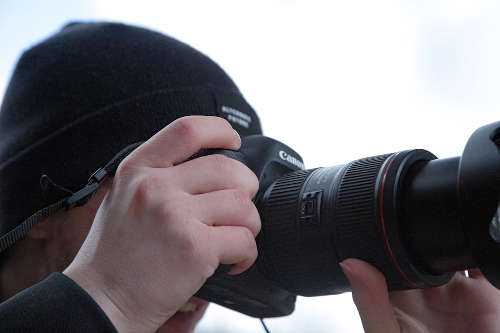 person holding black nikon dslr camera