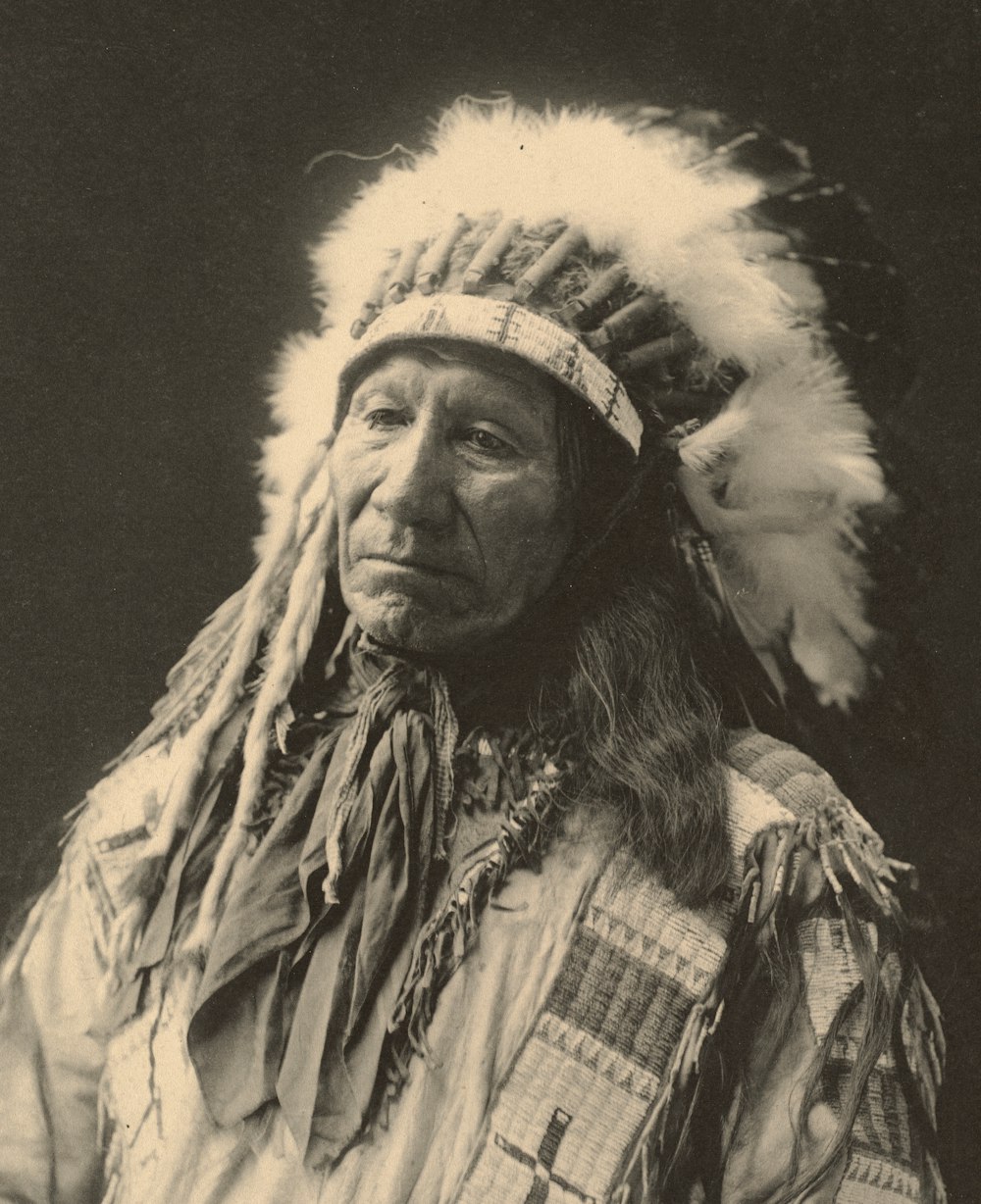 an old black and white photo of a native american man