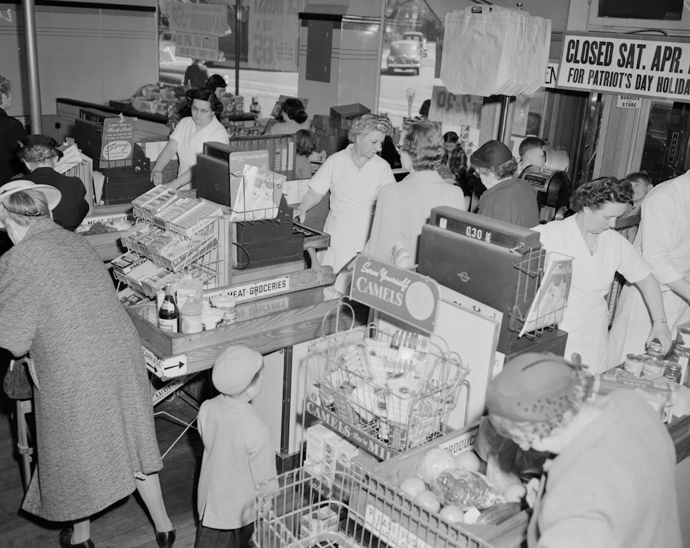 grayscale photo of people in store