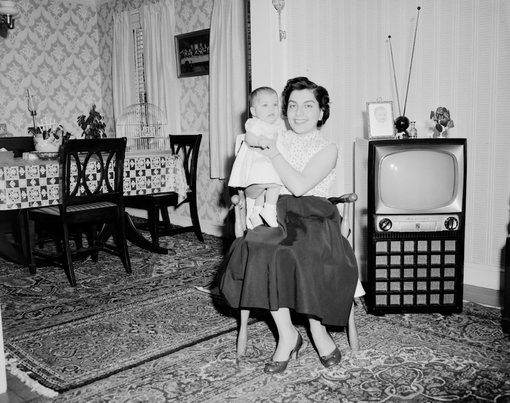 grayscale photo of girl in dress standing on carpet