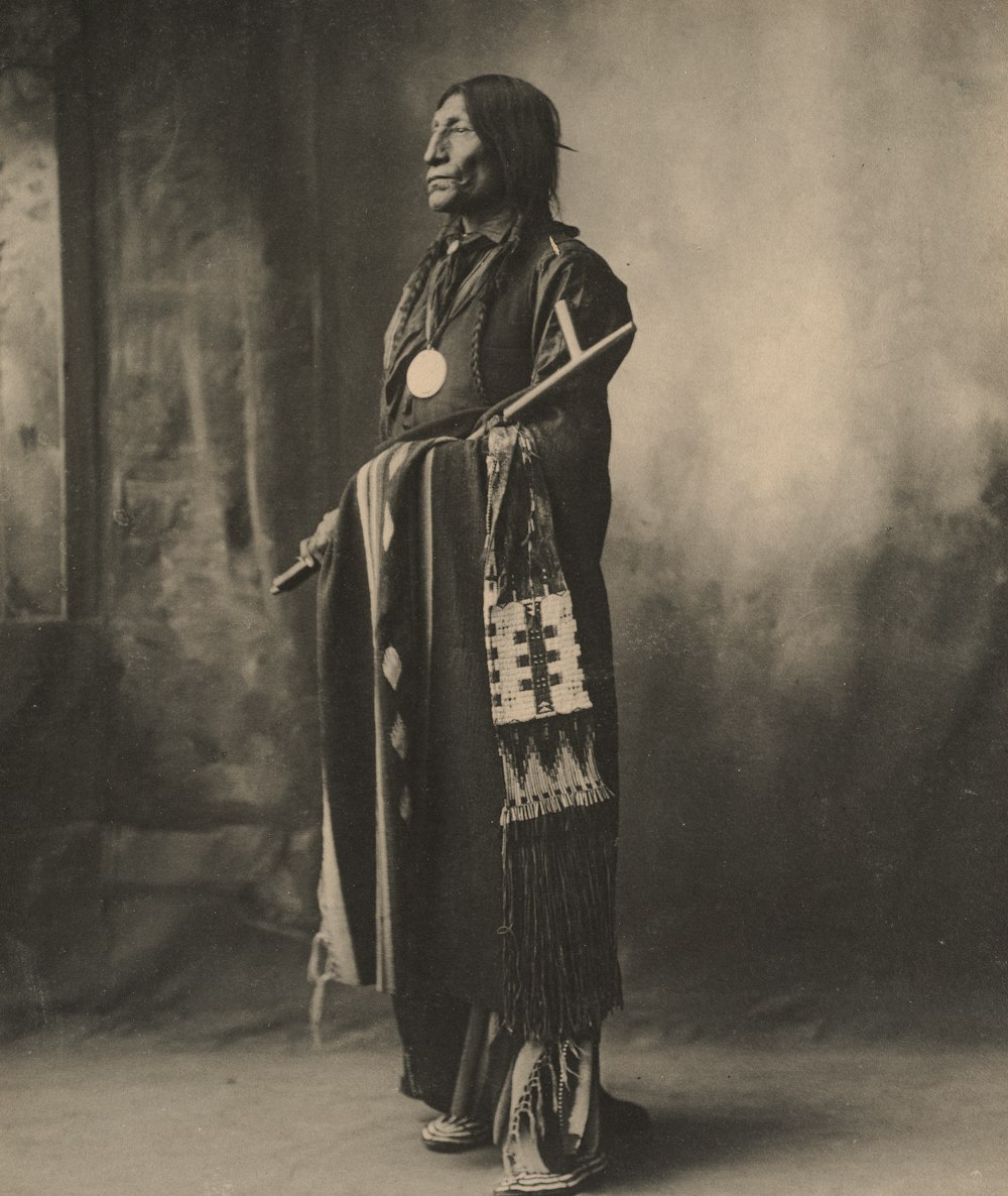 woman in black coat standing on gray concrete floor