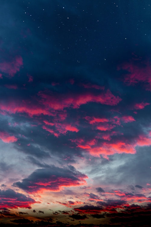 Clouds in shades of dark blue and magenta at sunset. 