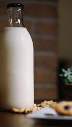 white plastic bottle on brown wooden table