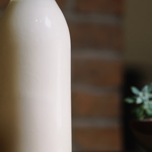 white plastic bottle on brown wooden table