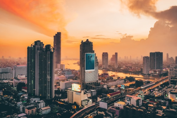 city skyline under orange and gray cloudy sky during sunset