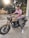 man in pink polo shirt riding on brown and black cruiser motorcycle