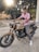 man in pink polo shirt riding on brown and black cruiser motorcycle