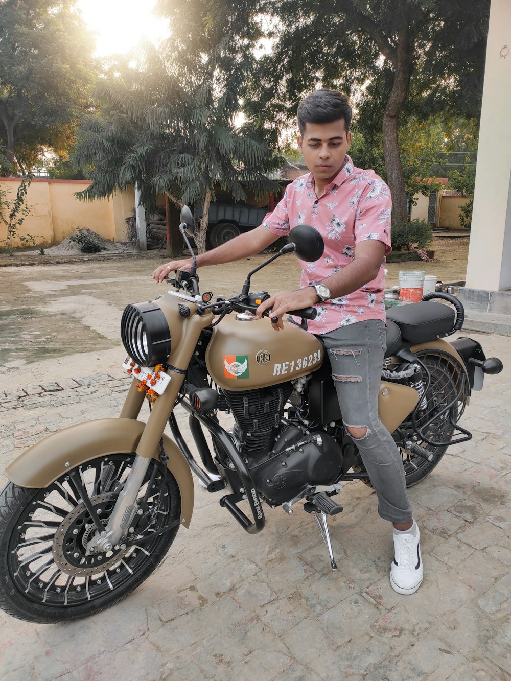 man in pink polo shirt riding on brown and black cruiser motorcycle