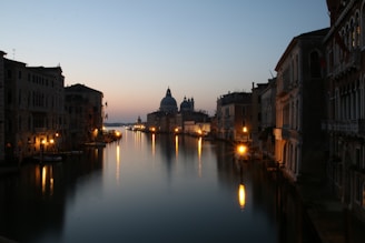 View of the Navigli canals at sunset with reflections and soft golden light.