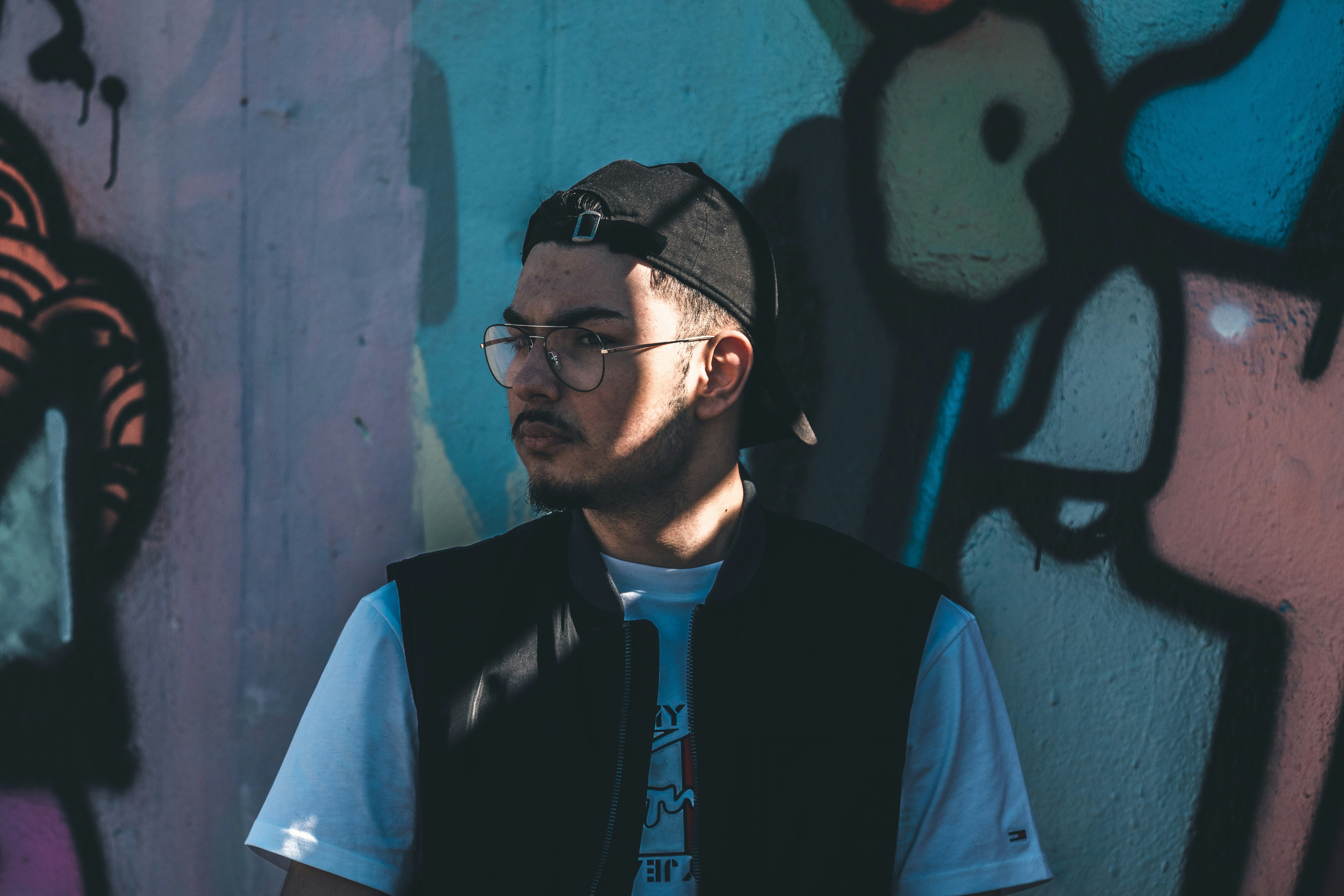 man in black framed eyeglasses and blue button up shirt