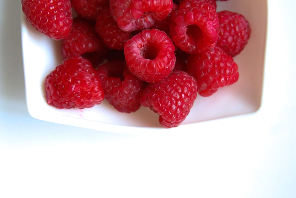 red raspberry on white ceramic plate