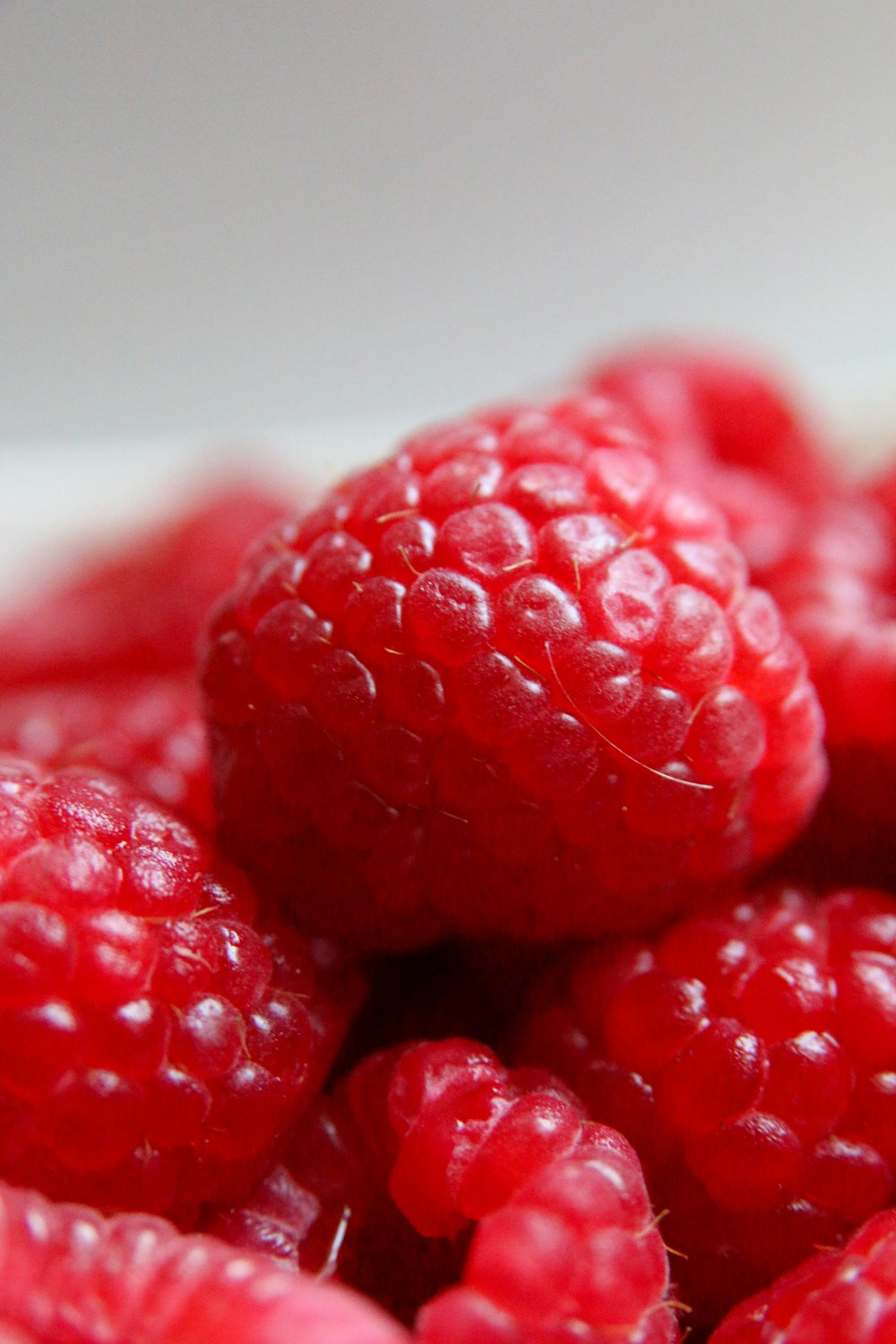 red round fruits on white ceramic plate