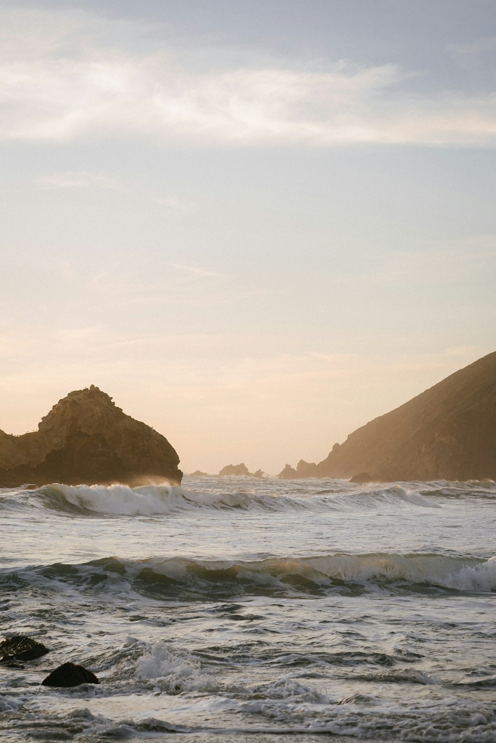 brown rock formation on sea during daytime