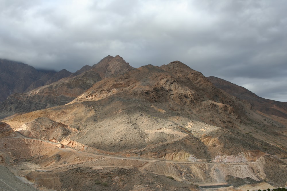 brown and gray mountain under white clouds during daytime