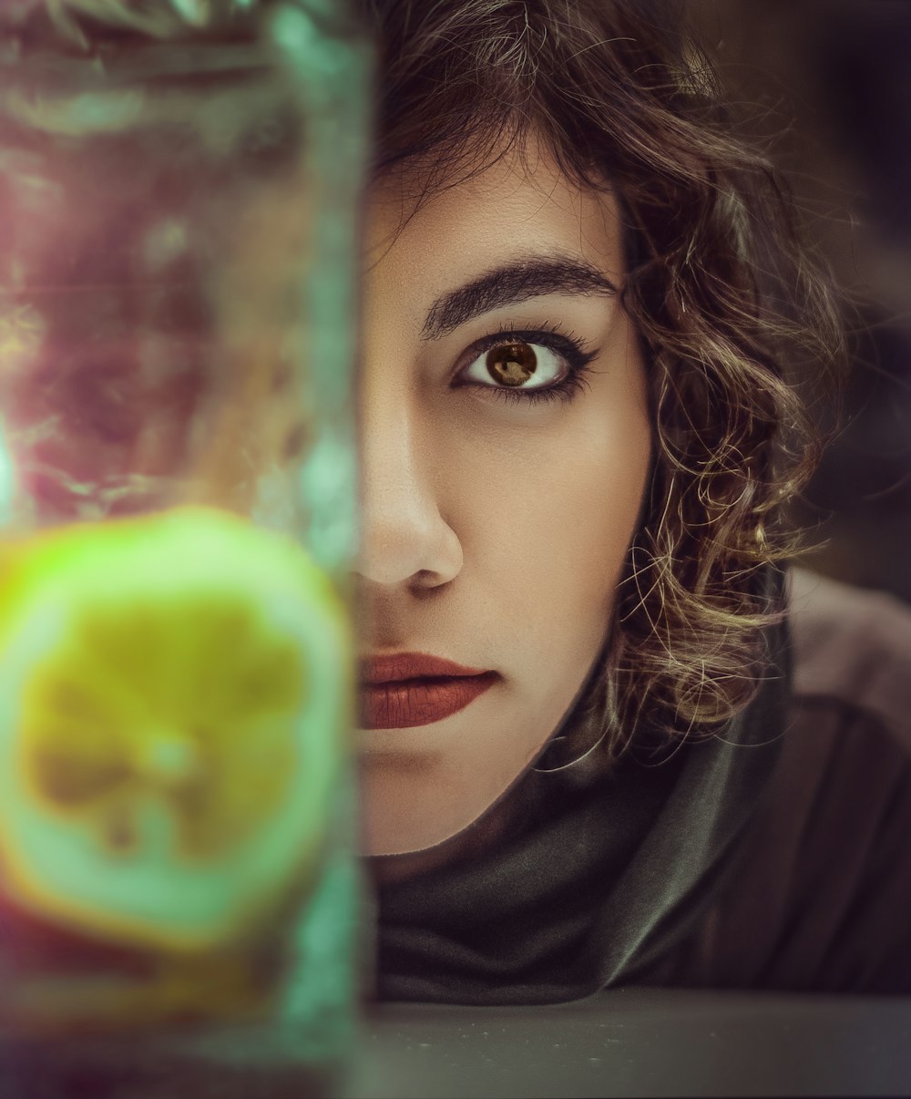 woman in black shirt holding green apple