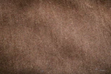 Close-up of luxurious textured fabric in sable and deep brown hues.