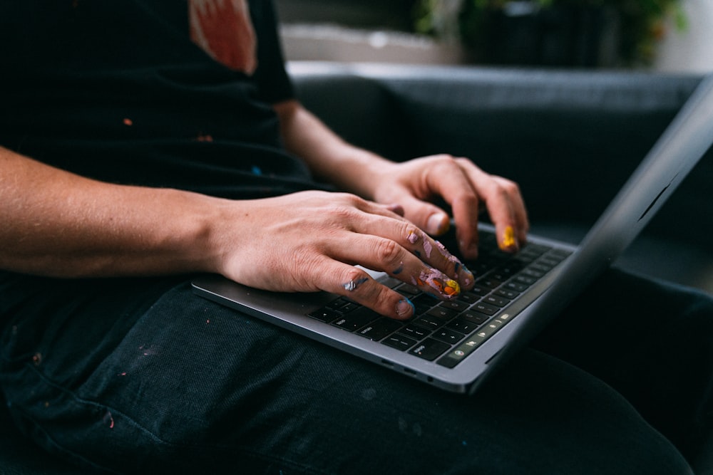 person using black and silver laptop computer