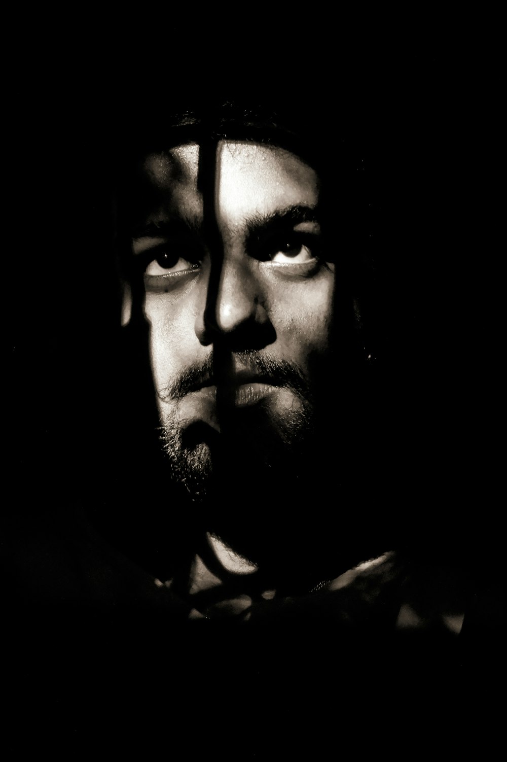 man in black shirt with black background