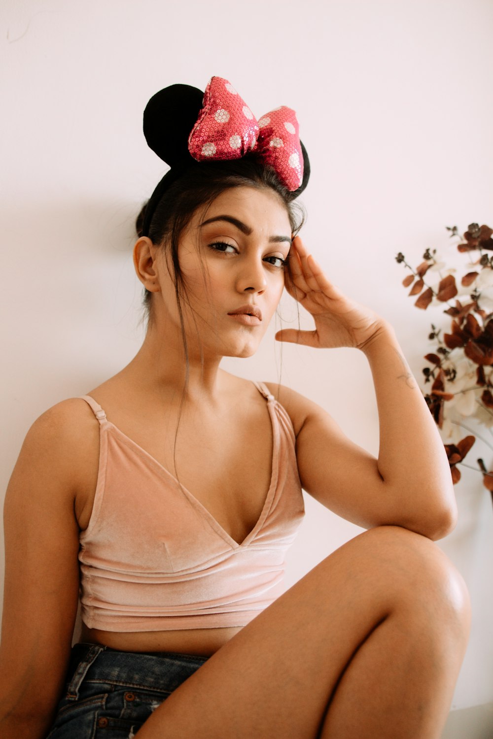 woman in pink tank top with red flower headband