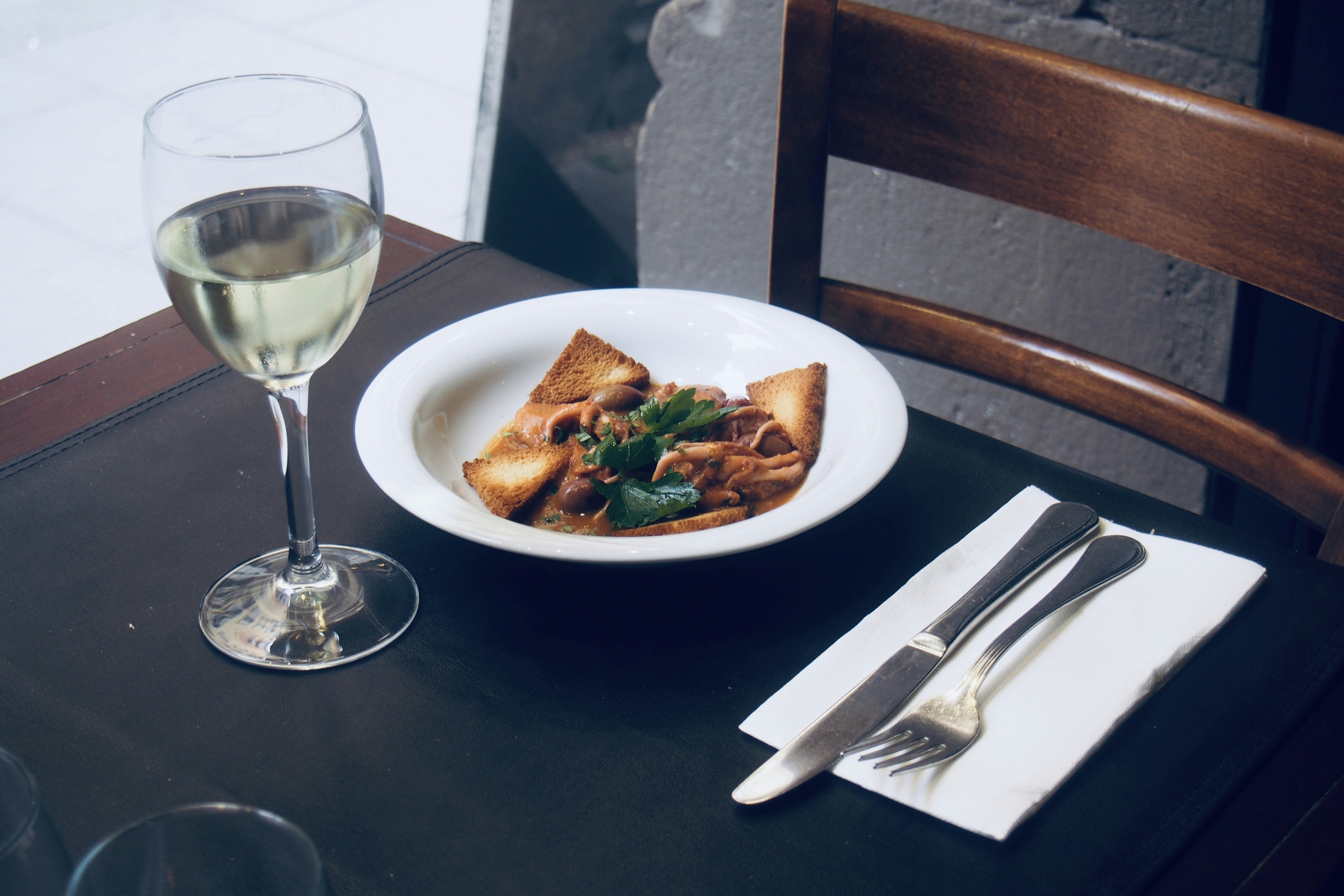 white ceramic plate with stainless steel fork and knife