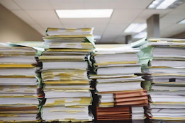stacks of paper documents and file folders