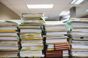 stacks of paper documents and file folders