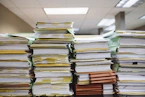 stacks of paper documents and file folders