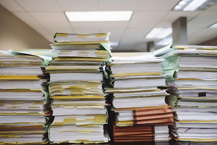 stacks of paper documents and file folders