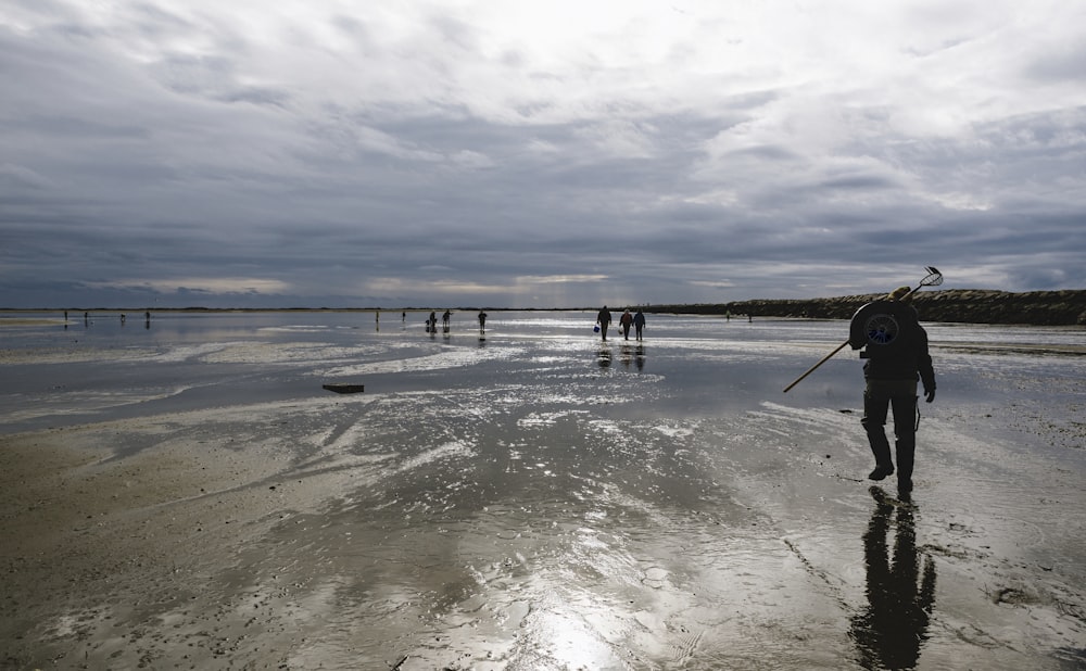 person walking on beach during daytime