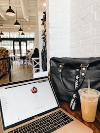 black leather handbag on brown wooden table
