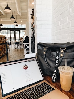 black leather handbag on brown wooden table